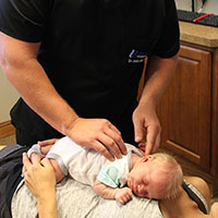 Dr Jordan adjusting tiny baby