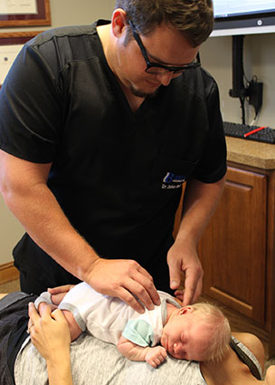 Dr. Bell adjusting tiny baby