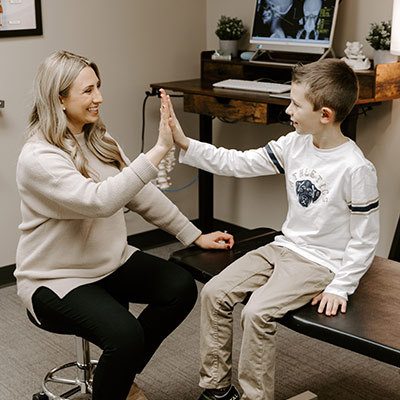 Dr Lanza high fiving a child patient