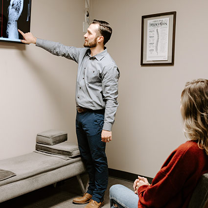 Dr Tarnowski reviewing x-rays with a patient