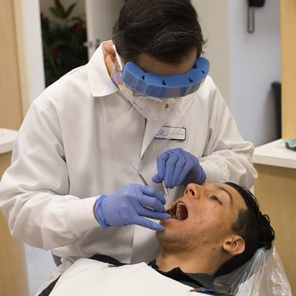Dr. Jimmy working inside mans mouth