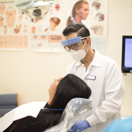 Dr. Jimmy talking to patient in chair