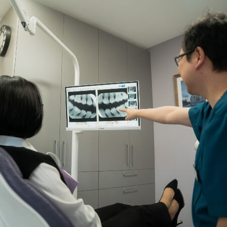 St Leonards dentist Dr Lau talking with patient about xrays