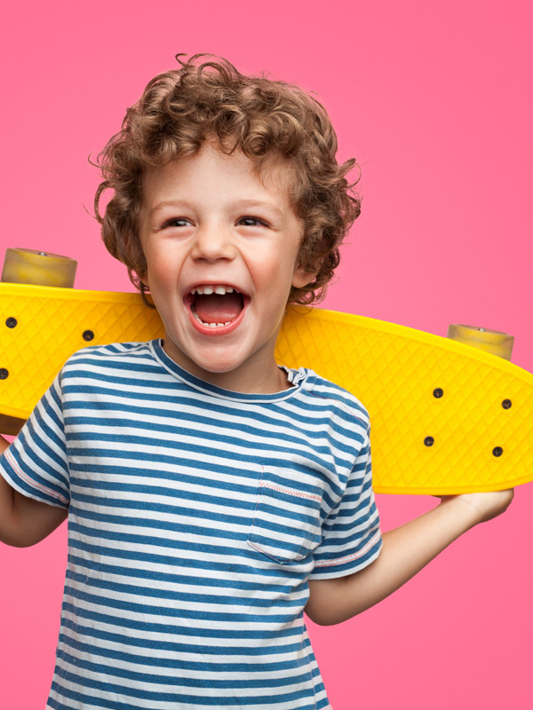 little-boy-smiling-with-yellow-skateboard