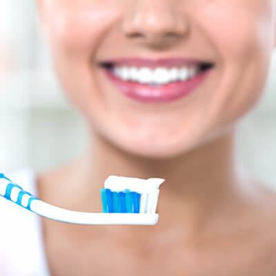 closeup of womans mouth with toothbrush