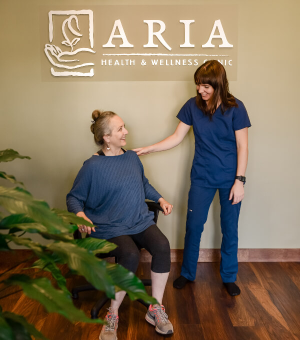 Aria Health and Wellness Clinic team member talking with patient
