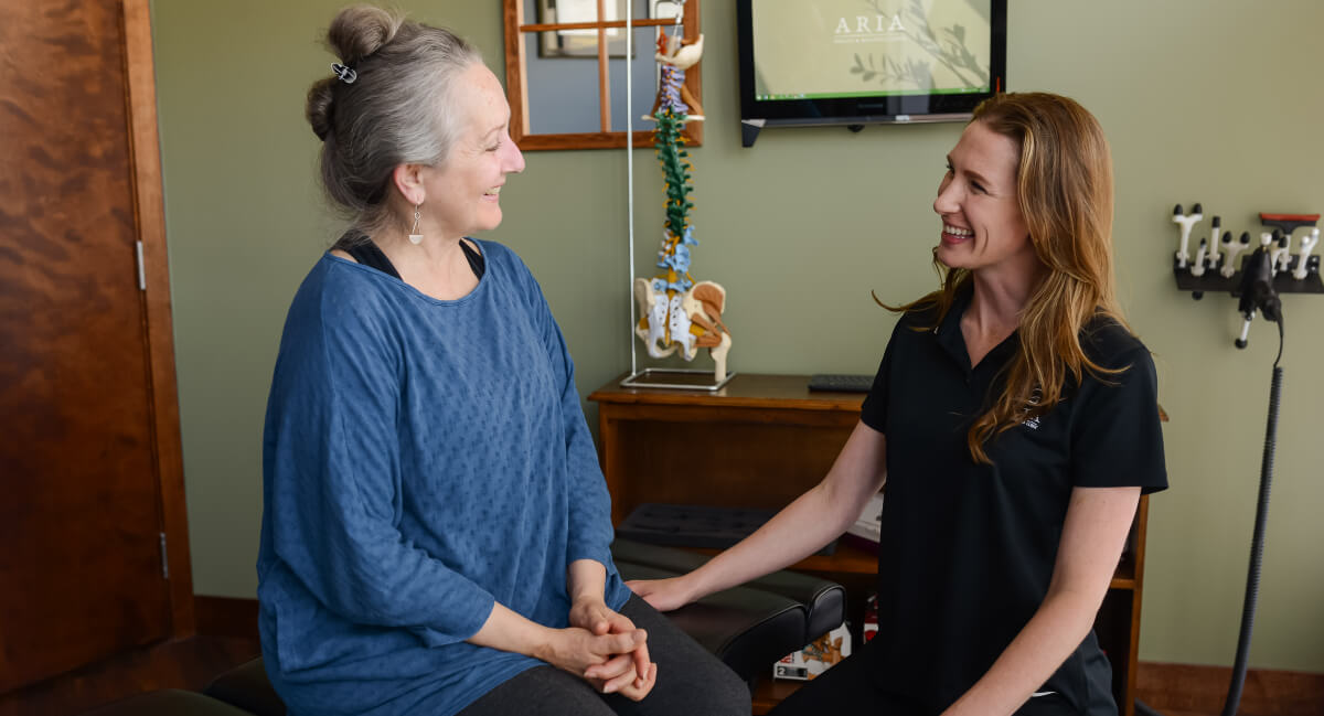 Victoria chiropractor talking to female patient