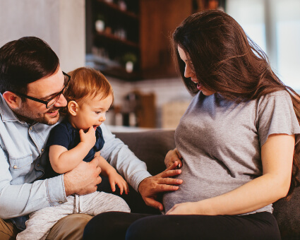 Dad, pregnant mom and young child