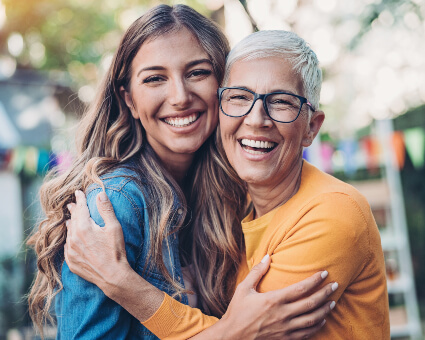 Mom and adult daughter hugging