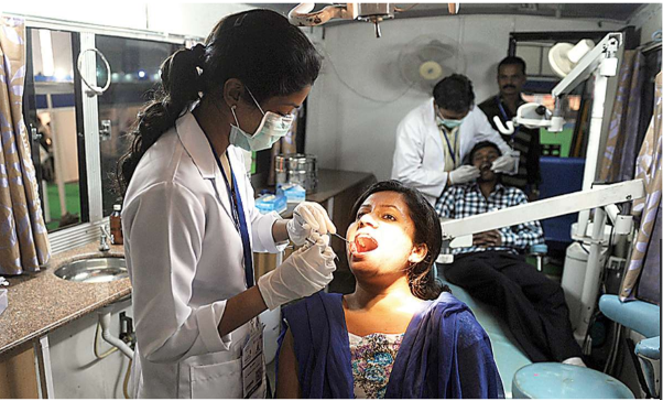 Dentist looking in patients mouth