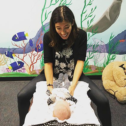 chiropractor smiling at a baby