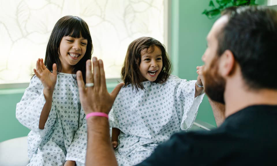 Kid patients high-five doctor