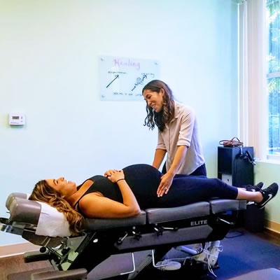 pregnant woman on chiro table with doctor