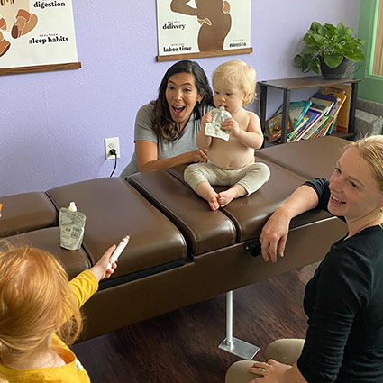 baby sitting on adjusting table