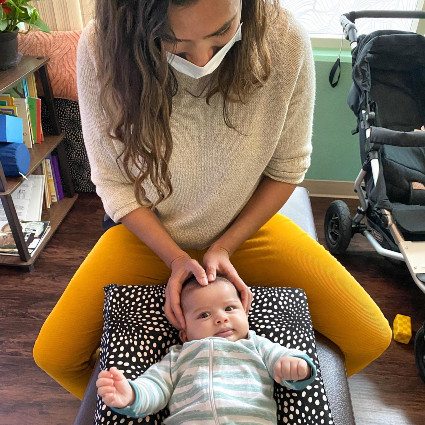 doctor adjusting babys neck