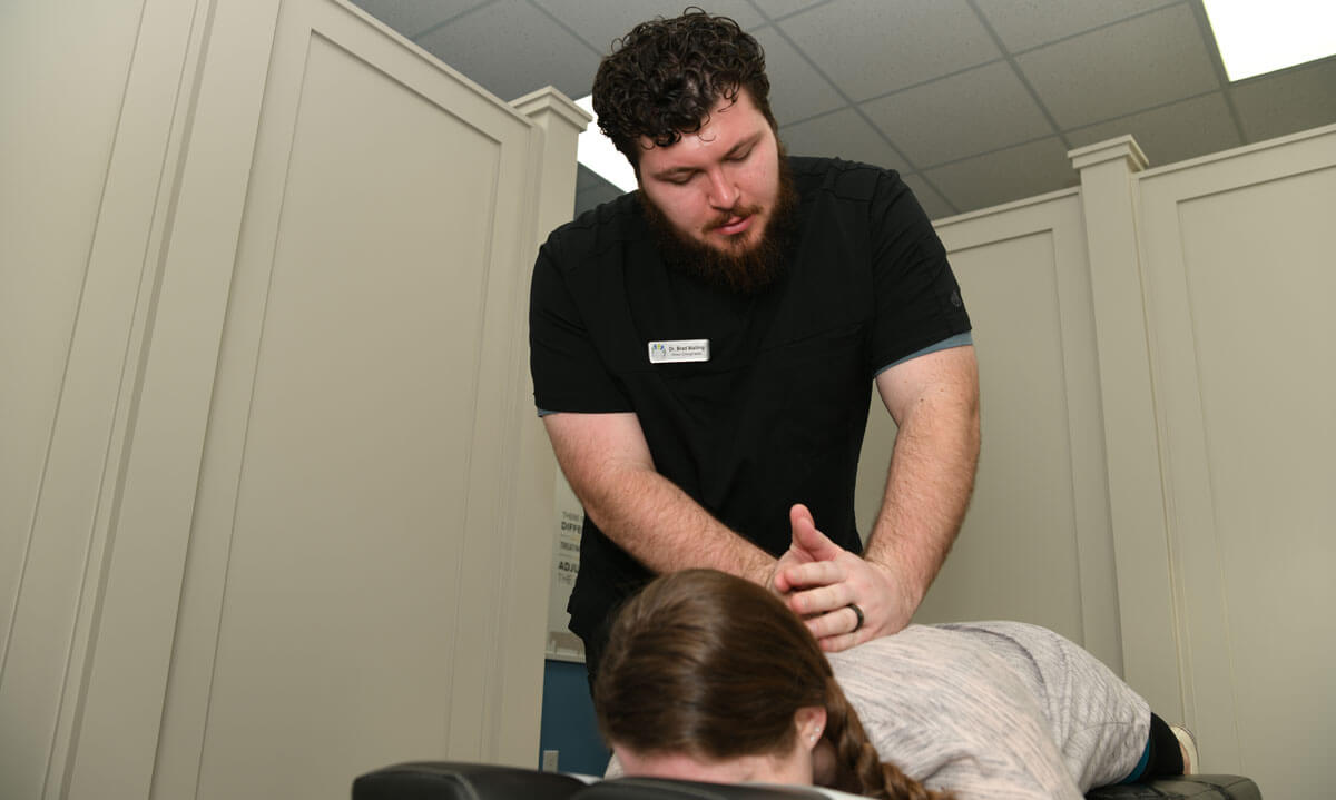 Dr. Brad adjusting patients back