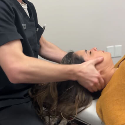 Adjusting woman's neck