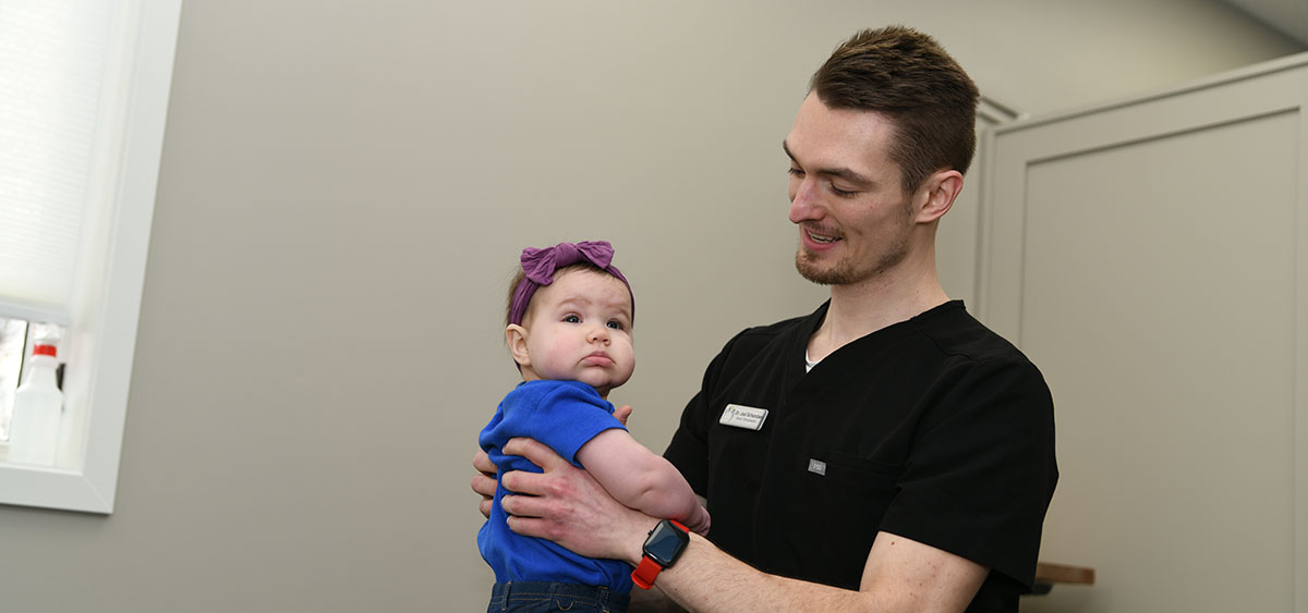 Dr. Joel holding baby