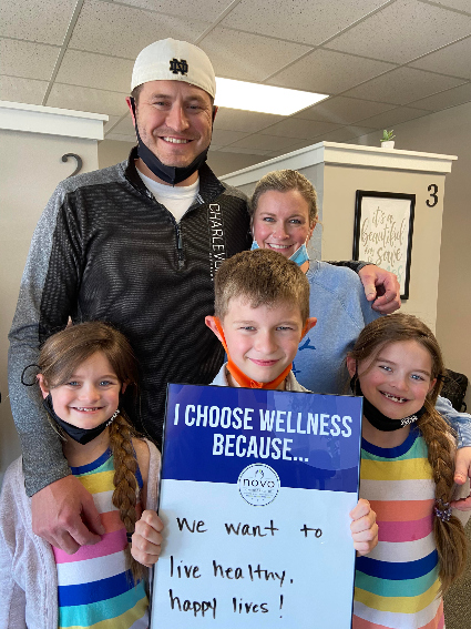 family with three kids smiling