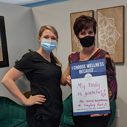 happy patient with  sign