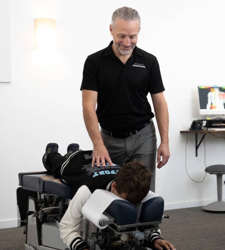 Semaphore chiropractor Dr Mathew adjusting patients back