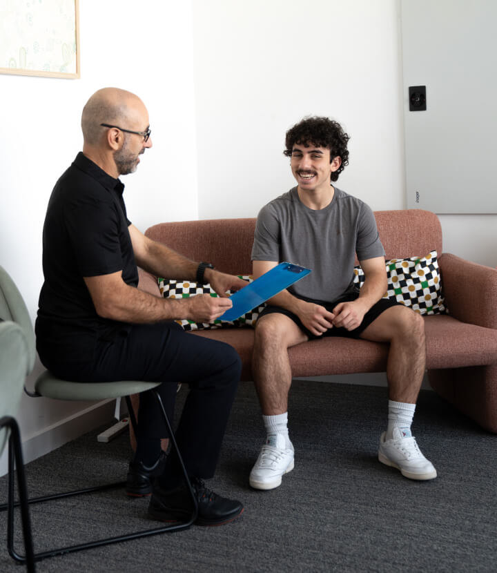 Semaphore chiropractor Dr Mario talking with a patient