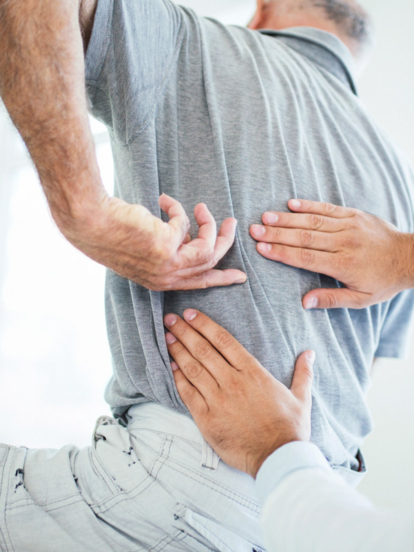man-with-backpain-at-chiropractic-visit