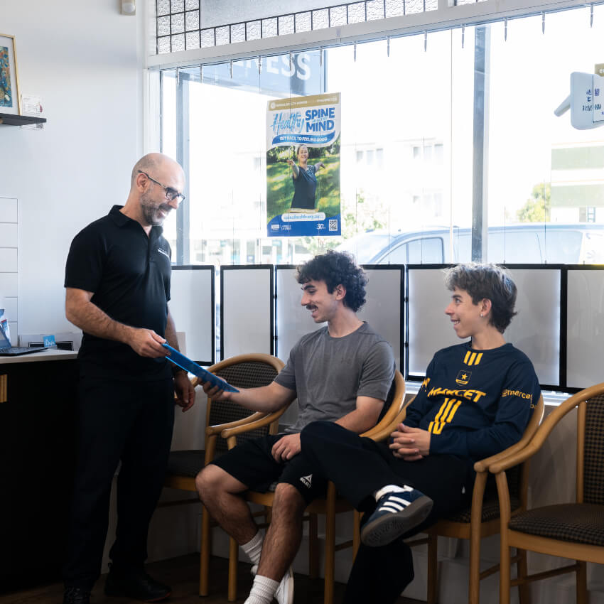 doctor talking with patients in waiting area