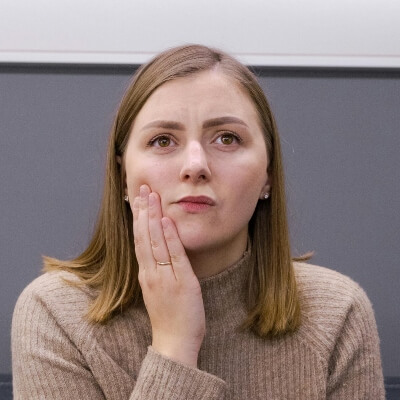 woman holding her jaw with tooth pain