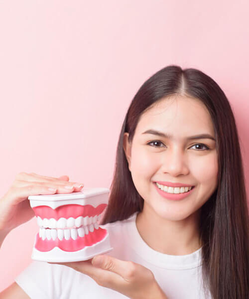 young-woman-holding-teeth-diy-so