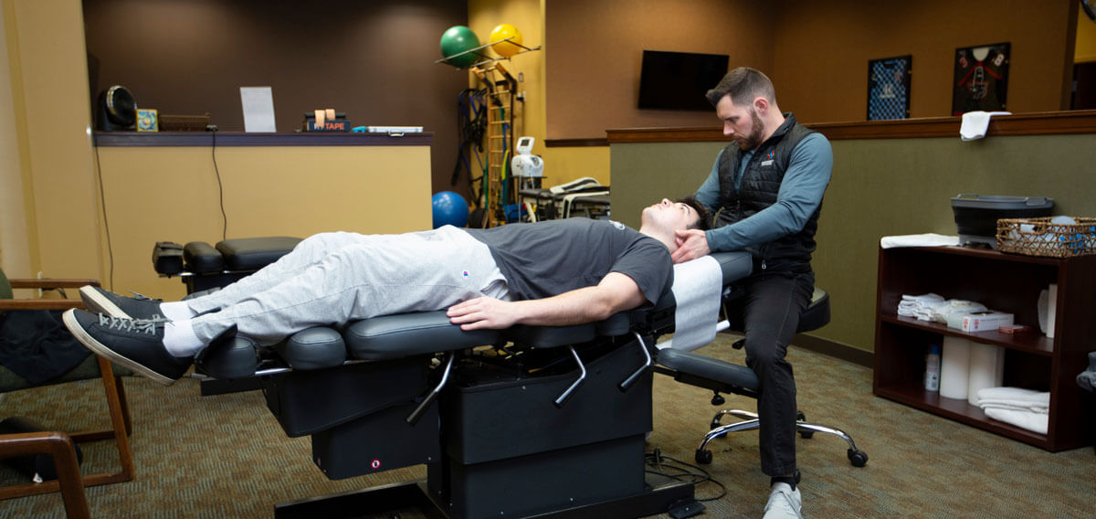 Midwest Sport and Spine Chiropractor adjusting man's neck