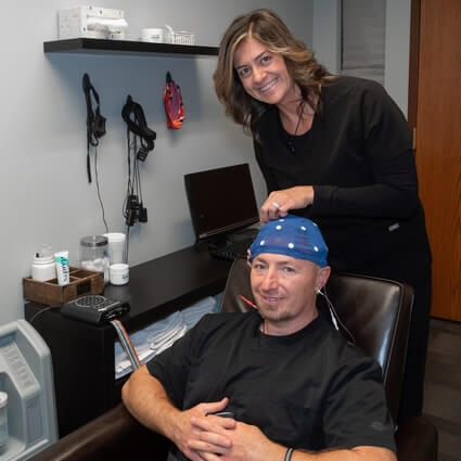 Dr sitting in chair for neurofeedback