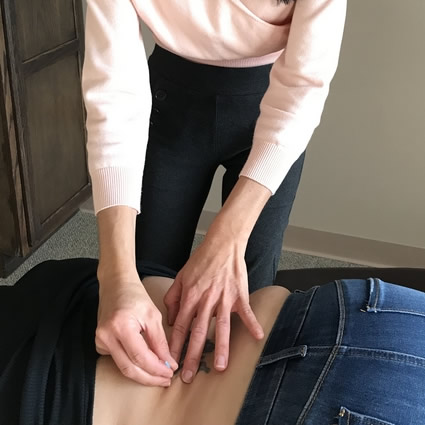 Dr Maria applying acupuncture needles
