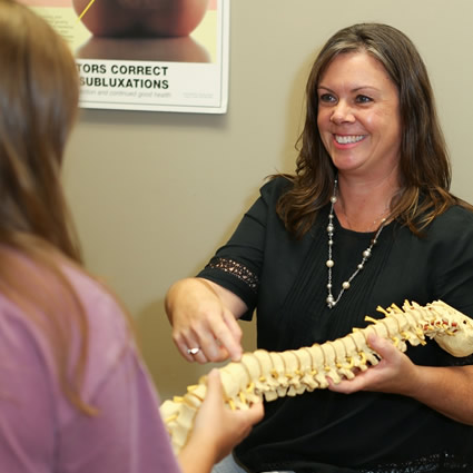 Dr. Wendi pointing to spine model