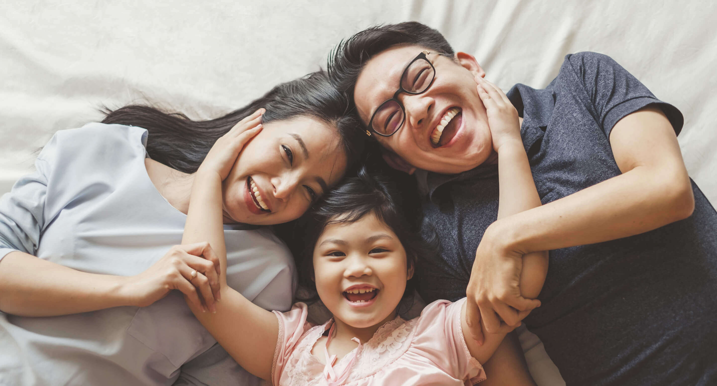 Smiling family of three