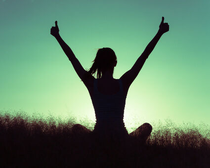 Sitting woman giving thumbs-up with both hands