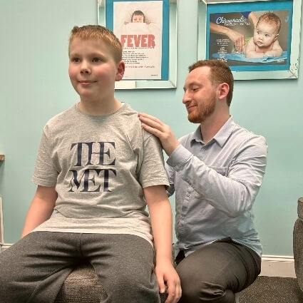 Dr Cooper adjusting childs back