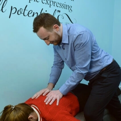 Dr Cooper adjusting womans back