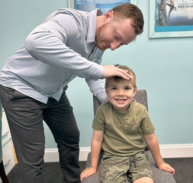 Cranford chiropractor Dr. Cooper checking kid patient