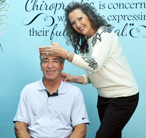 Cranford chiropractor Dr. Carol with patient