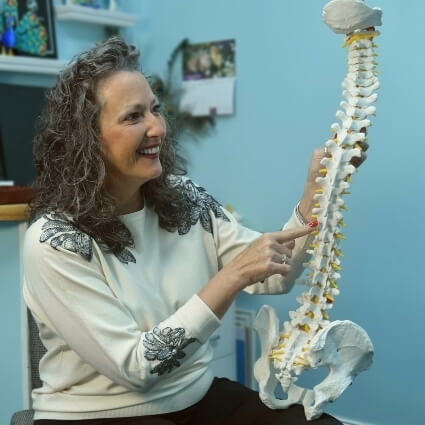 Dr Carol adjusting pointing at spine