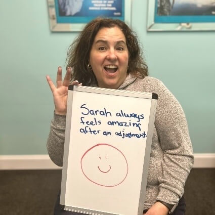 person holding white board