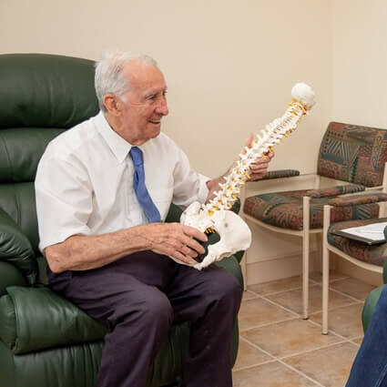 Dr Mac holding spine