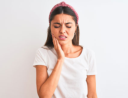 Young woman with tooth pain