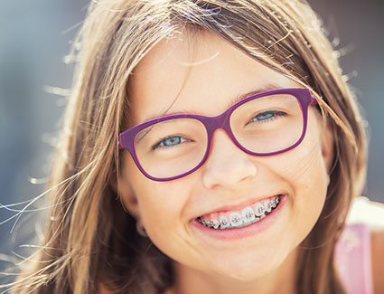 Young girl smiling with braces