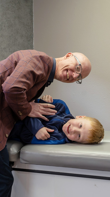 Dr. Josh Biberdorf adjusting girl on table