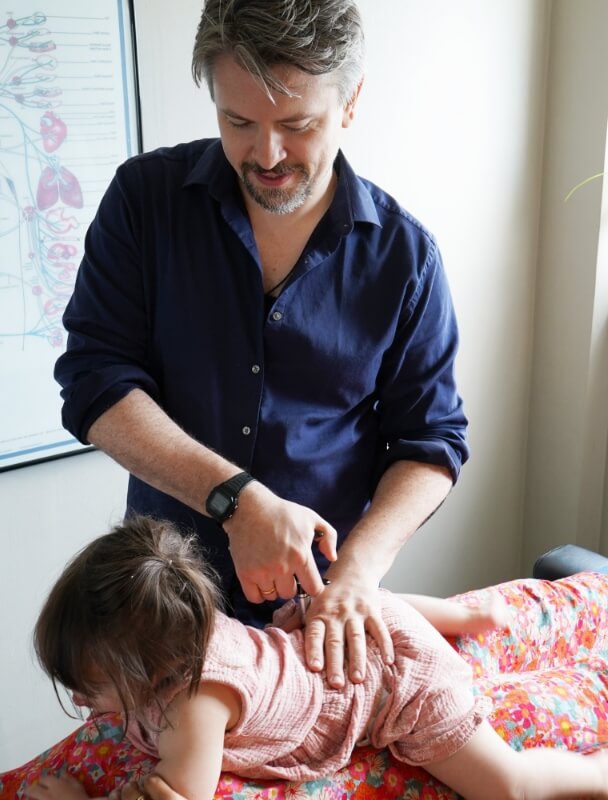 Dr. Anthony using Activator on child