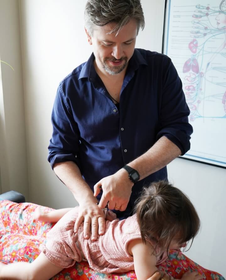Dr. Anthony using Activator on child