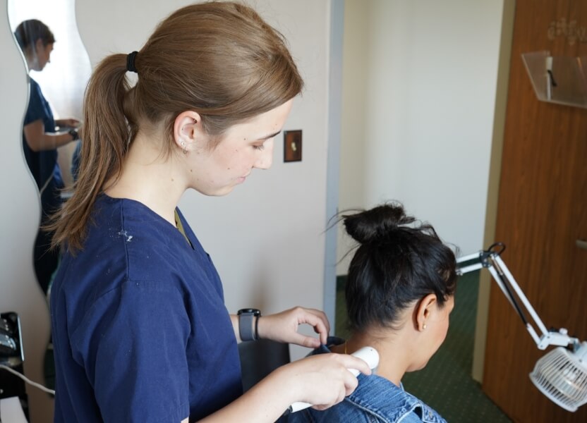 using tool on patient's neck