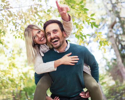 Man giving a piggy-back ride to his wife
